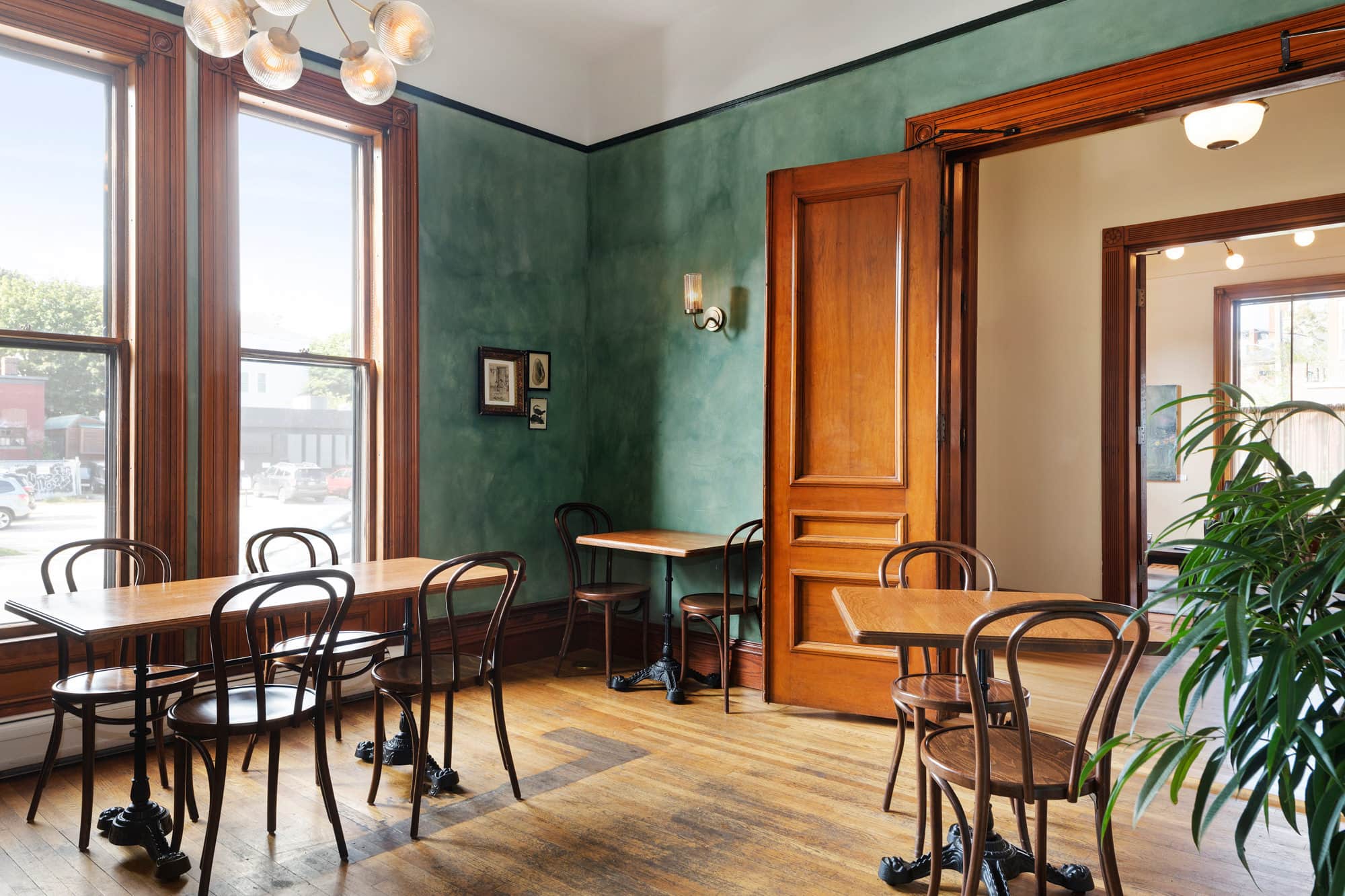 Cozy dining area with wooden tables and chairs in a Portland Maine boutique hotel.