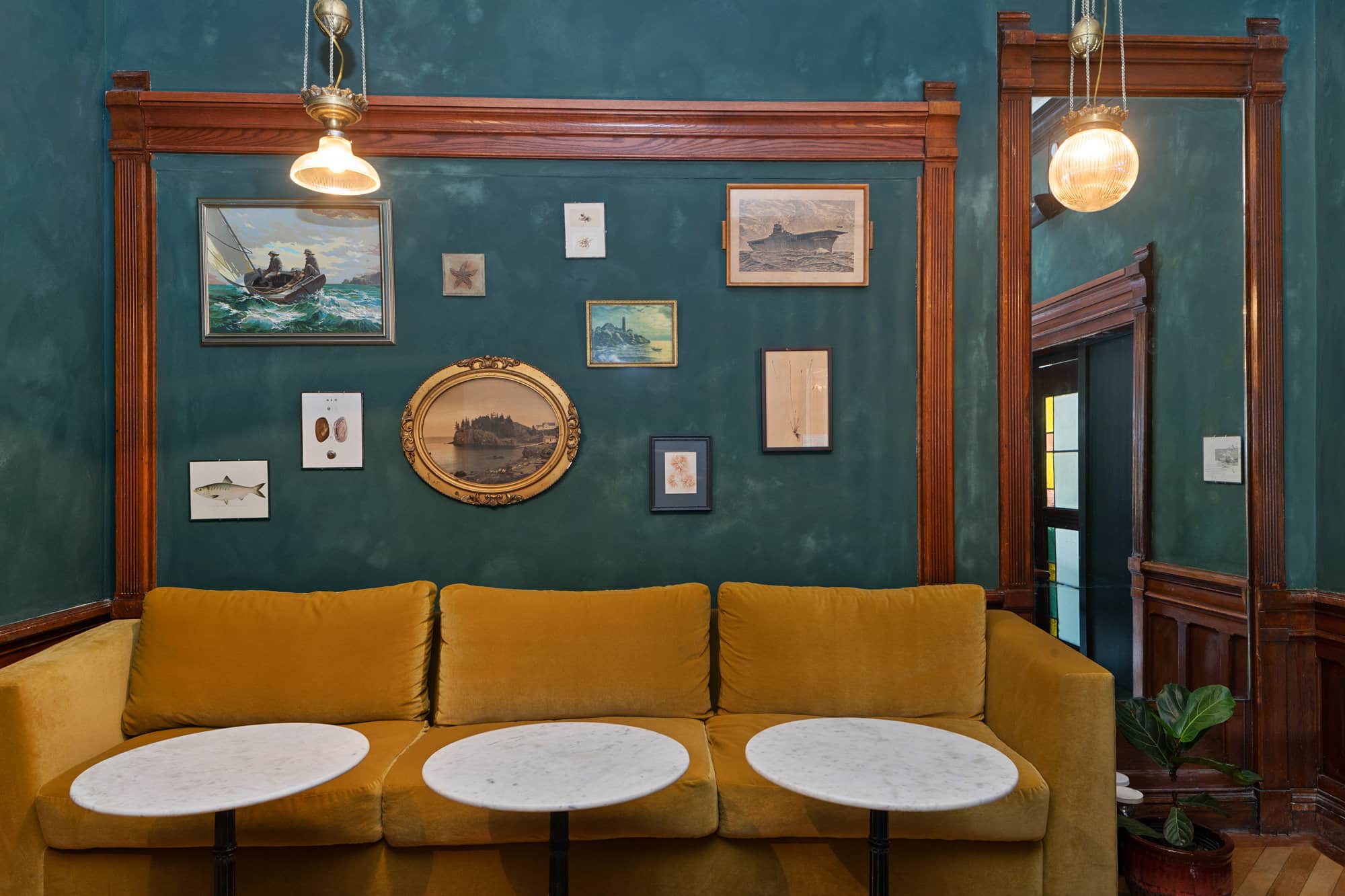 Cozy nook with art-filled walls and plush seating in Portland Maine boutique hotel.