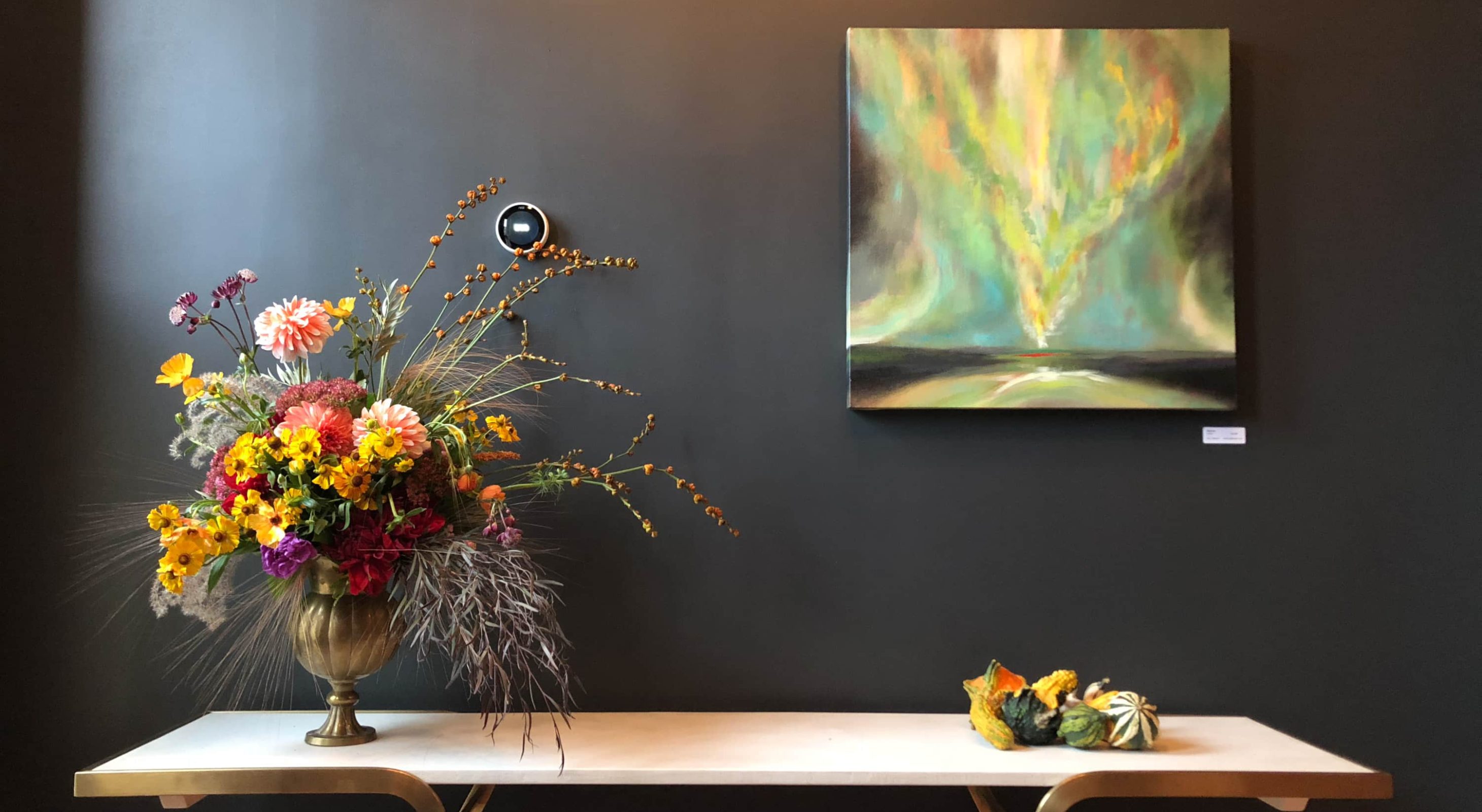 Luxury boutique escape: Elegant floral arrangement and abstract art enhancing ambiance.