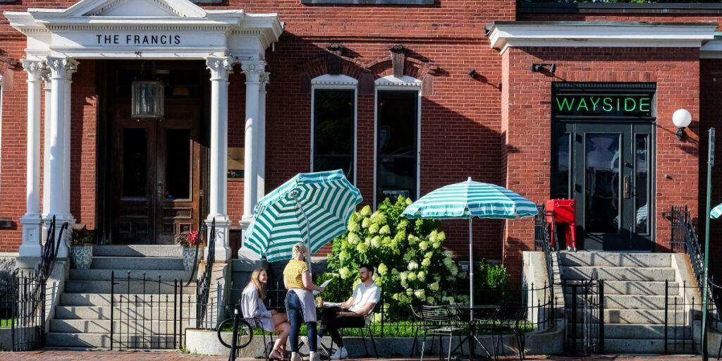 The Francis hotel entrance in Portland Maine's historic West End with outdoor seating.