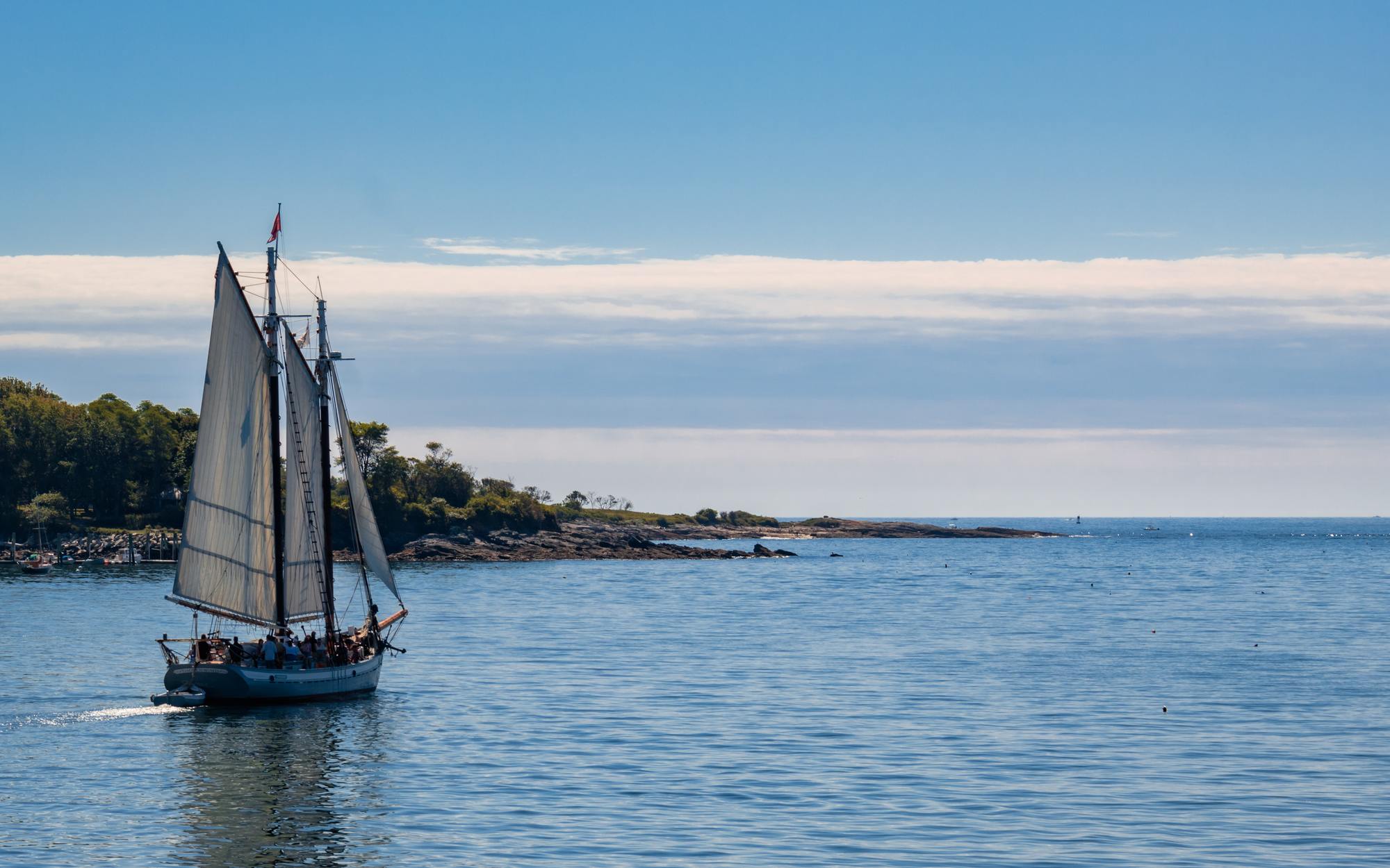 Sailboat navigating the serene waters, perfect for a Portland Maine luxury hotel getaway.
